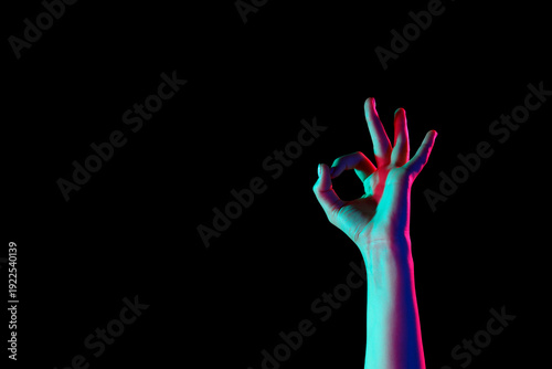 Toned female hand showing O...