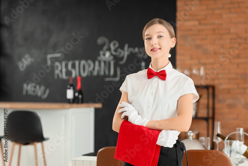 Smiling young waitress in r...