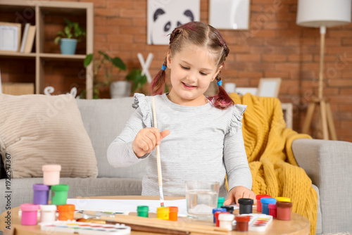 Little girl painting with b...