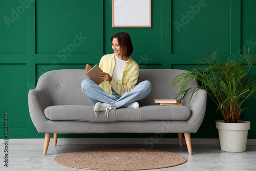 Pretty young woman reading ...