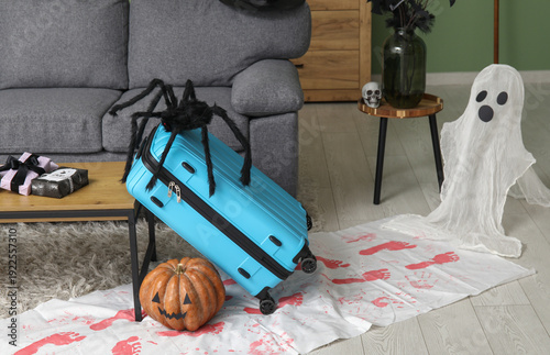 Suitcase with toy spider an...