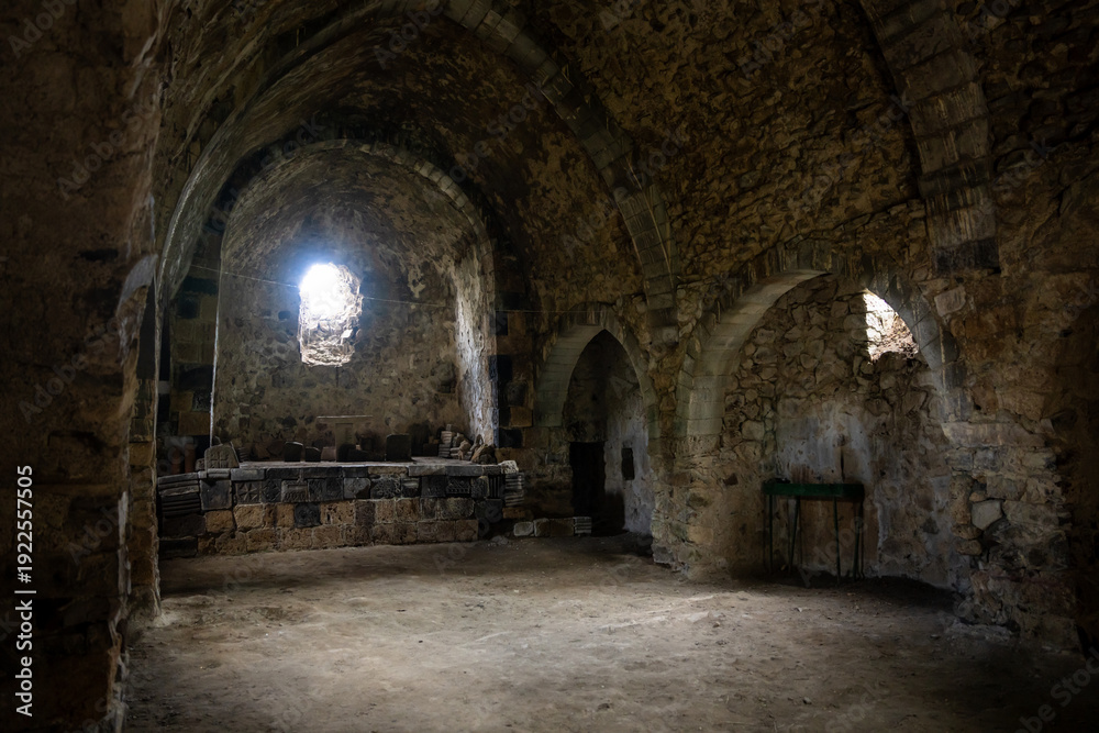 Fototapeta premium Interior of an ancient Armenian church, featuring historic stone architecture, intricate carvings, and serene spiritual ambiance reflecting centuries of religious heritage.