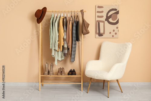 Rack with clothes and armch...