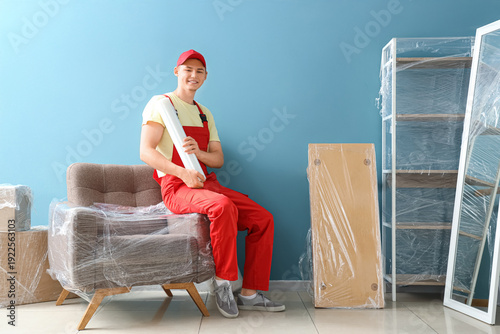 Male worker with roll of st...