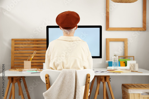Young woman in beret workin...