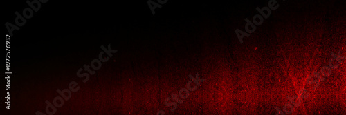 Photos Intense red light illuminating a grainy surface on black background, dramatic glowing texture with deep shadows and organic noise