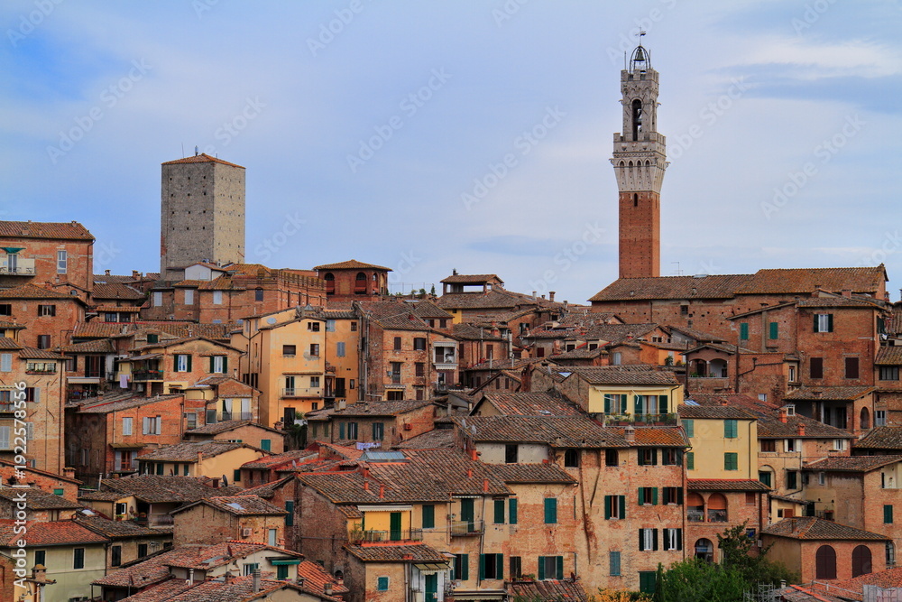 Fototapeta premium Siena, medieval town in Tuscany, with view of the Dome & Bell Tower of Siena Cathedral, Italy