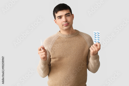Young man with nasal drops ...