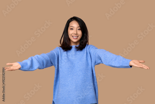 Young Asian woman opening a...