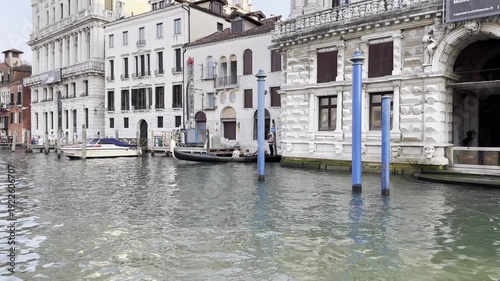 Venetian canal boat journey through historic archways and waterfront architecture