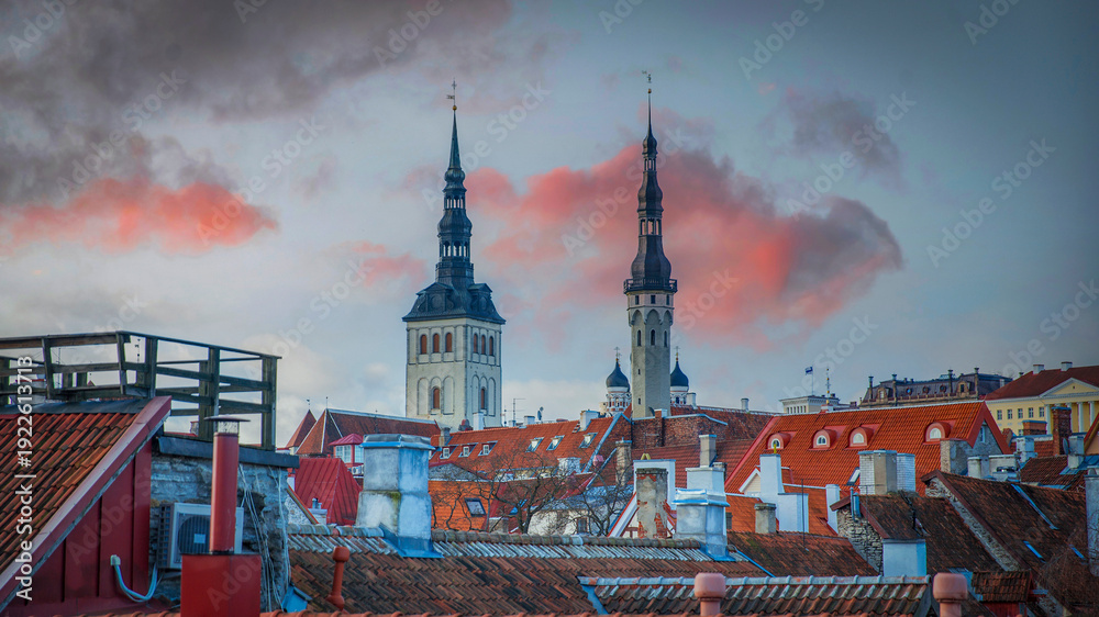 Obraz premium Scenic view over the red rooftops of Tallinn Old Town with church towers at sunset, Estonia