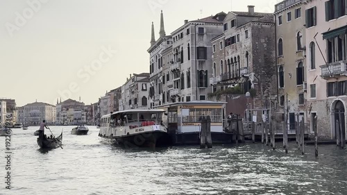 Gondolas and boats navigating venice's grand canal amidst historic architecture