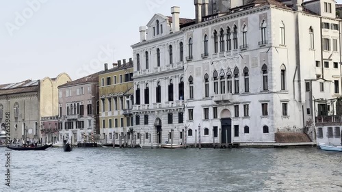 Gondolas glide along historic venetian canal with majestic architecture