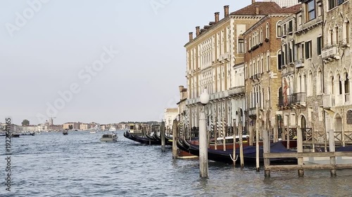 Gondolas gently swaying in scenic venetian canal at dusk