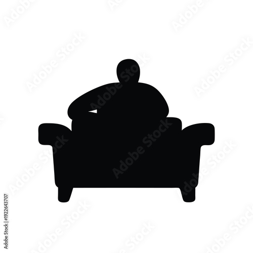 Black silhouette of a person lounging comfortably on a large sofa