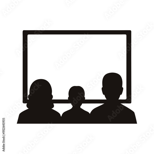Silhouette of a family watching a movie or show on a screen