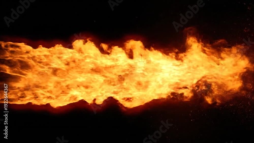 Powerful jet of fire erupting against a dark background.