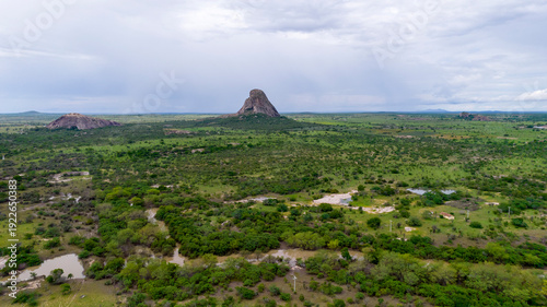Fényképezés Rock formation in the middle of the green field, aerial view