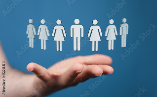 Hand holding human figures....