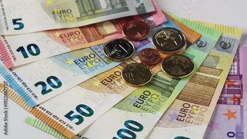 Euro banknotes coins rotating together white surface. Detailed 10 20 50 100 200 bills spinning. Financial success business wealth investment concept. High quality currency footage economy banking grow