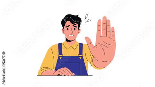 Concerned man wearing blue overalls holding up his hand in a stop gesture as a warning or signal to halt actions.