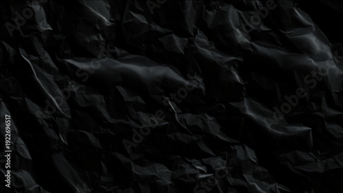 Crumpled black plastic sheet texture background