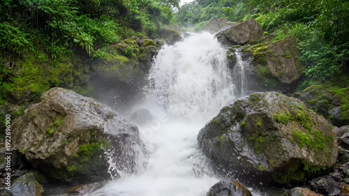 Majestic waterfall cascading over mossy rocks in lush forest - 4k video