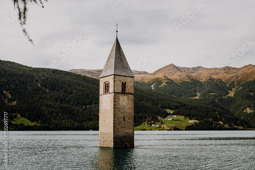 Famous half sunken 14th century church bell tower in Lake Reschen (Reschensee) at Curon Venosta, South Tyrol, Italy