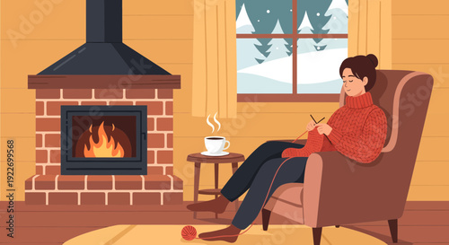 Woman knitting in a cozy armchair by the fireplace enjoying a warm drink.