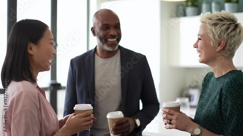 Diverse colleagues enjoying coffee and conversation in a modern office setting fostering collaboration networking and positive workplace relationships for business success