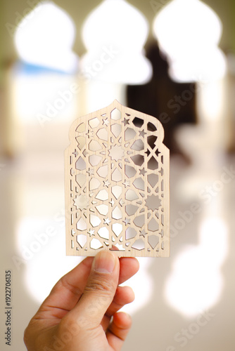 Islamic geometric ornament on mosque floor with blurred arch background. Elegant Ramadan and Eid Mubarak religious decoration concept