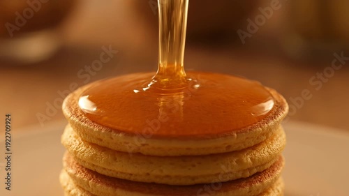 Golden syrup drizzled over fluffy pancakes stacked high - 4k video