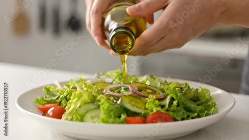Person pouring olive oil on fresh salad with vegetables - 4k video