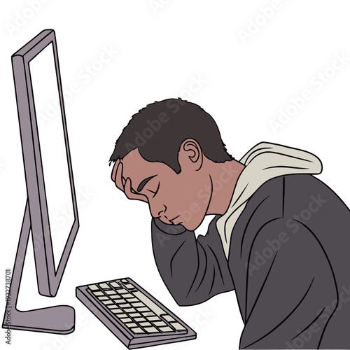 Man looking tired while sitting at computer desk