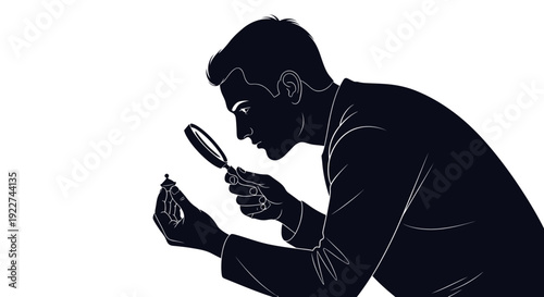 Man examining an object with a magnifying glass closely.