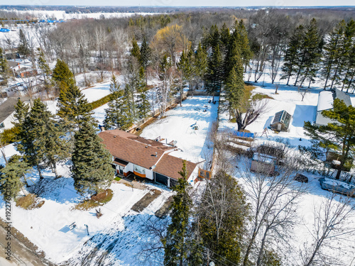 Residential property showcasing a house with an attached garage, surrounded by evergreen trees and snow covered ground along glen cedar drive, ramara, simcoe county, ontario, canada
