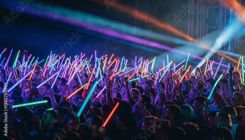 Vibrant Concert Crowd Waving Glowing LED Light Sticks Creating Electric Atmosphere During Live Music Performance