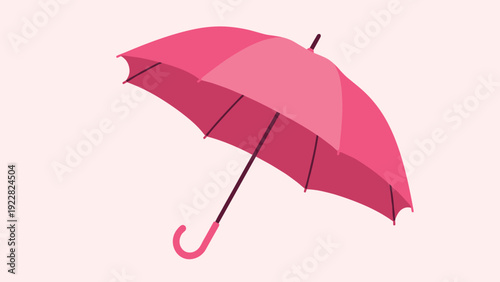 Bright pink umbrella fully opened to provide shelter from the rain or sun against a light soft pink background for a clean minimalist look.