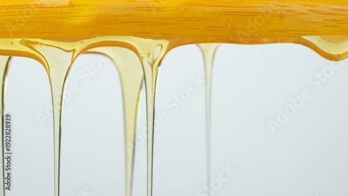 Liquid natural organic honey flow, macro texture.