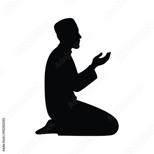Silhouette of a muslim man kneeling in prayer isolated on white background