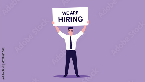 Professional man in a white shirt and tie holding up a large sign that says we are hiring on a purple background.