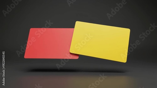 Red and Yellow Cards: A conceptual display of a red card and a yellow card. The bold colors stand out against the dark background.