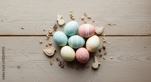 Seven pastel colored Easter eggs rest on weathered wooden planks with small.