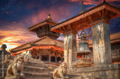 Ancient Taleju Bell and temples at Patan Durbar Square in Nepal at sunset