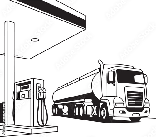 Large tanker truck refueling at a gas station pump with a canopy overhead on a clear day