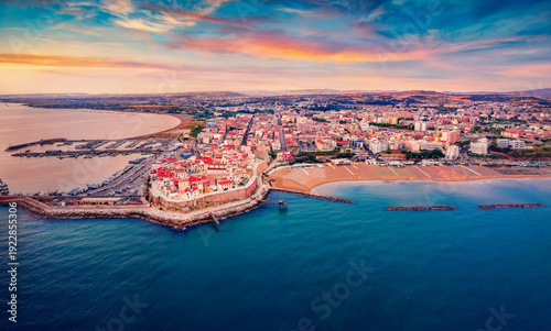 Colorful summer view from flying drone of Sant'Antonio beach. Incredible morning cityscape of Termoli port. Breathtaking sunrise on Adriatic sea. Traveling concept background.