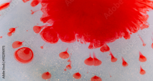 Ink splatter blur. Pigment droplet. Red liquid spill on sparkling white background. Bright color fluid splash abstract art explosion.
