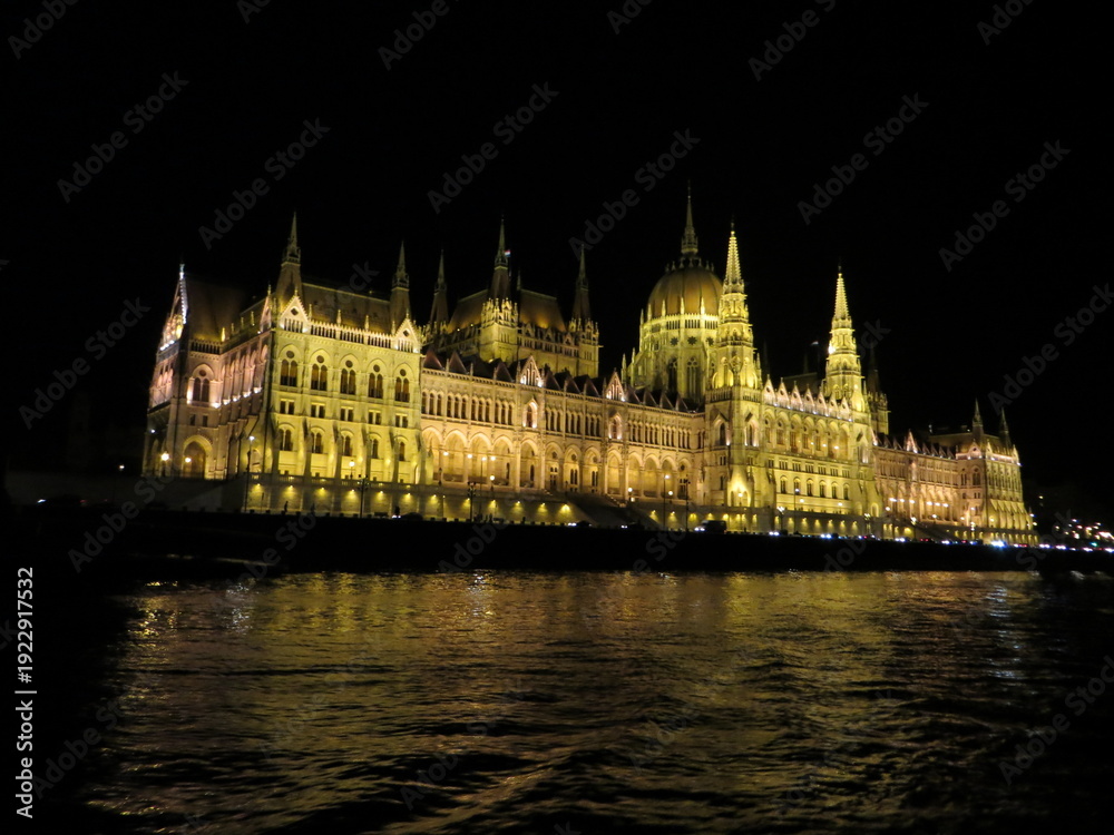 Obraz premium The Hungarian Parliament at night with dark sky and reflection in Danube river. It was designed in Neo-Gothic style, although it also bears Renaissance and Baroque stylistic flourishes.