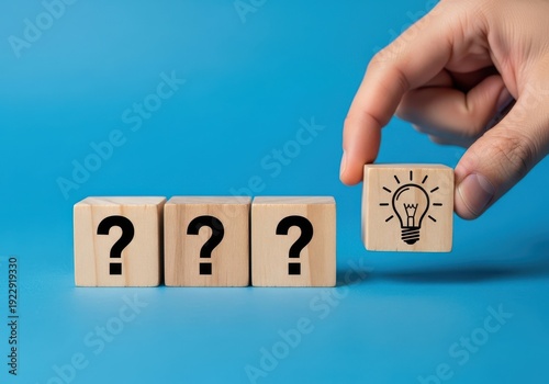 A hand placing a block with a lightbulb on it next to three blocks with question