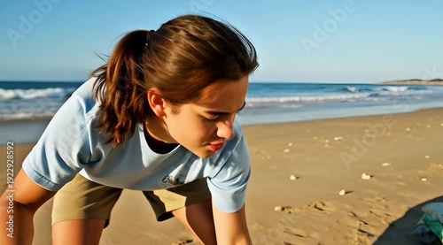 Volunteer Picking Up Plastic Waste on Beach for Ocean Conservation